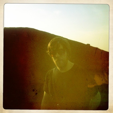 Luke O’Malley in sunglasses, photographed outdoors in golden light